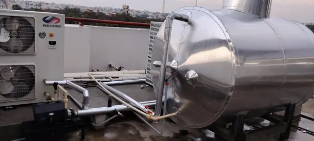 Redstone-branded heat pump beside an insulated hot water tank