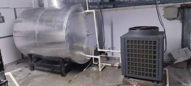 Heat pump connected to an insulated hot water tank in a plant room
