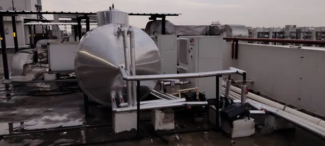 Insulated hot water tank with heat pumps and circulation pumps on a rooftop