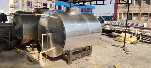 Pair of insulated hot water storage tanks on a city rooftop