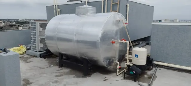 Insulated hot water tank with circulation pump and expansion vessel on a rooftop