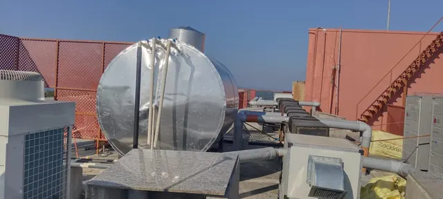 Insulated hot water tank among rooftop plant equipment
