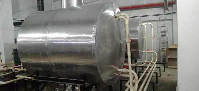 Large insulated hot water tank in an indoor plant room